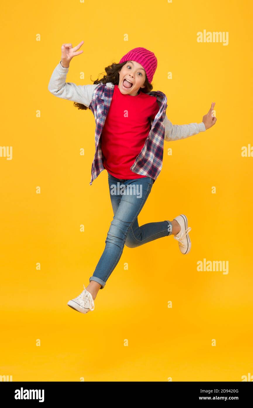 hurrying child in hat running forward for seasonal holiday and vacation, free time and leisure. Stock Photo