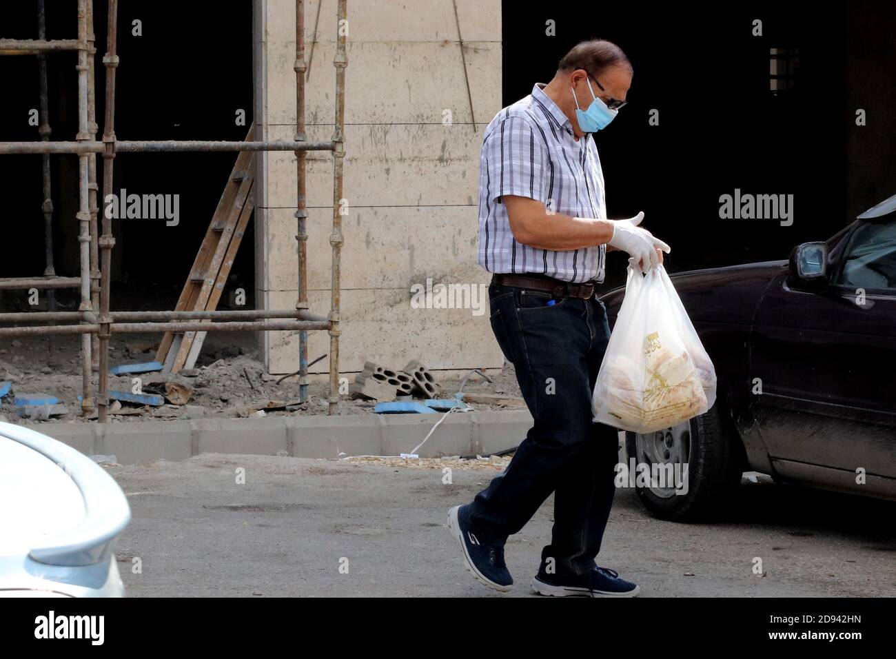 Amman, Jordan. 2nd Nov, 2020. A man wearing a face mask walks on a street in Amman, capital of Jordan, on Nov. 2, 2020. Jordan on Monday recorded 5,877 new coronavirus cases, the highest daily spike in the country so far, raising the tally to 81,743. Credit: Mohammad Abu Ghosh/Xinhua/Alamy Live News Stock Photo
