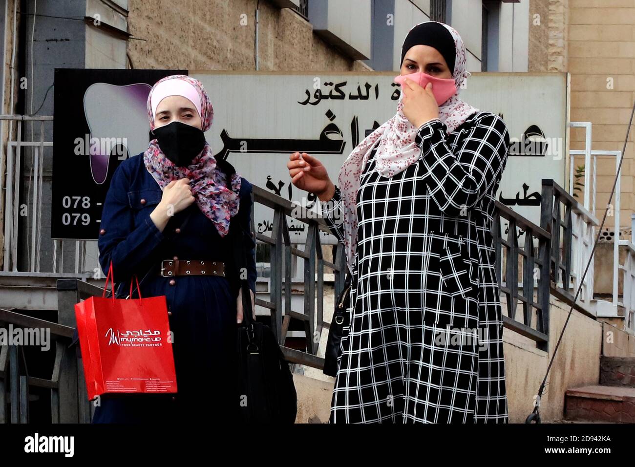 Amman, Jordan. 2nd Nov, 2020. People wearing face masks are seen on a street in Amman, capital of Jordan, on Nov. 2, 2020. Jordan on Monday recorded 5,877 new coronavirus cases, the highest daily spike in the country so far, raising the tally to 81,743. Credit: Mohammad Abu Ghosh/Xinhua/Alamy Live News Stock Photo