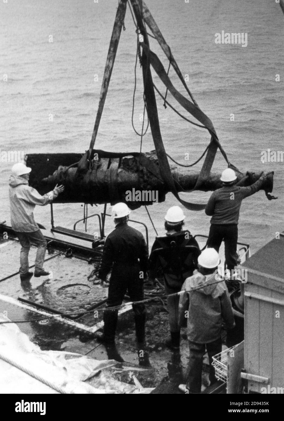 A BRONZE GUN IS HAULED ABOARD THE MARY ROSE SALVAGE SHIP SLEIPNER