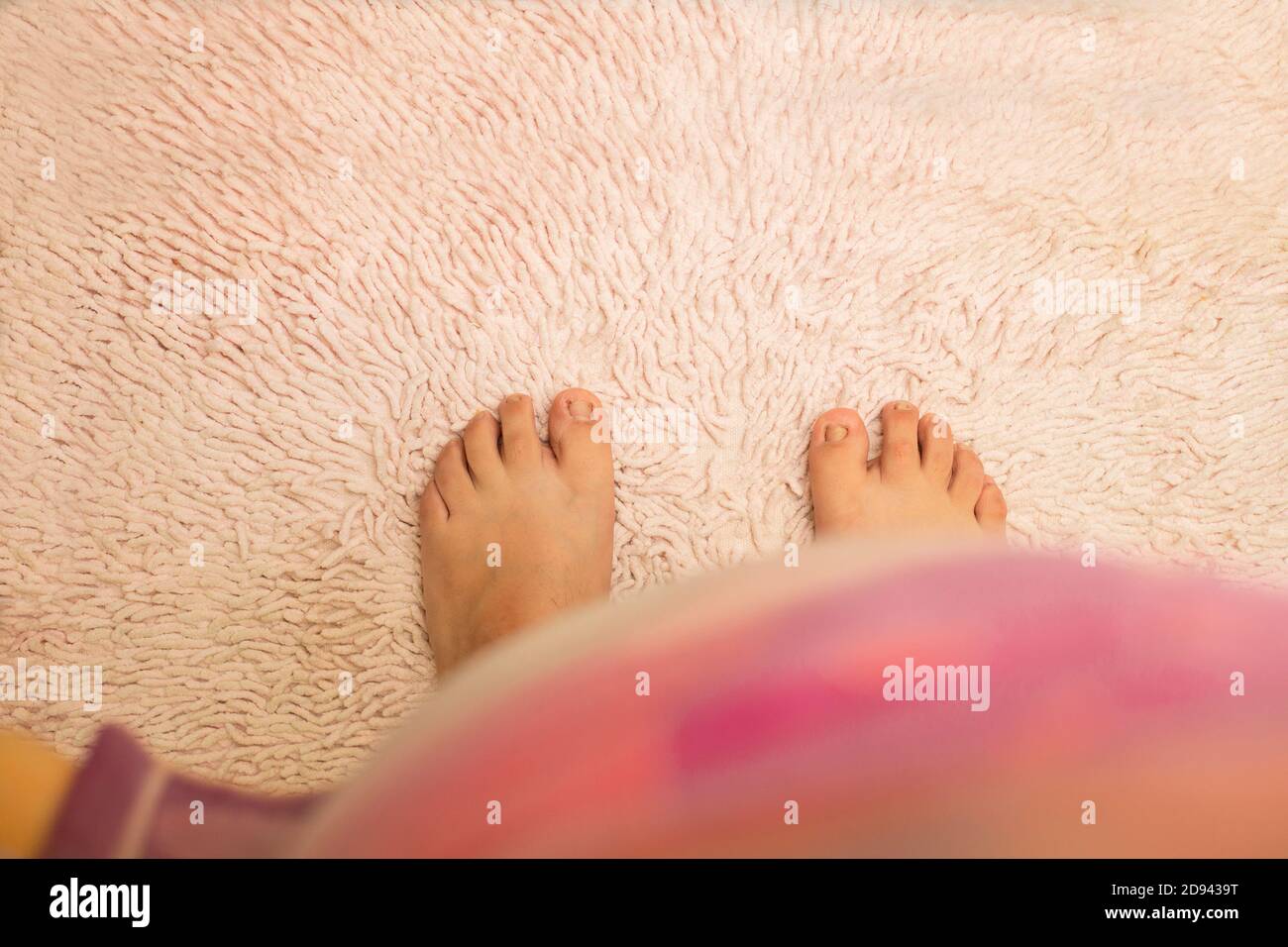 woman feet top view on bath mat - Barefoot on the mat Stock Photo