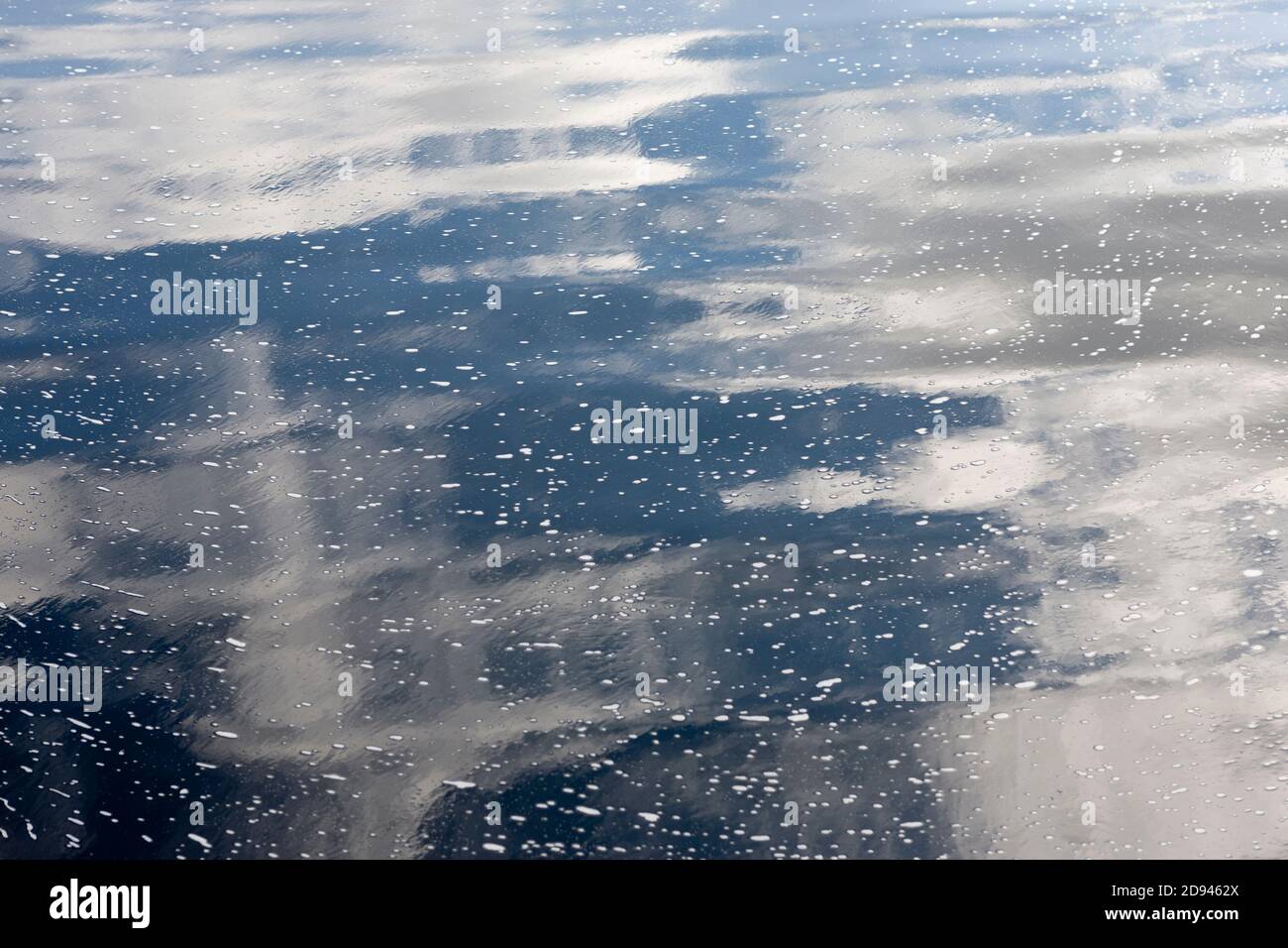 Blue Sky and Clouds Reflected in River Stock Photo
