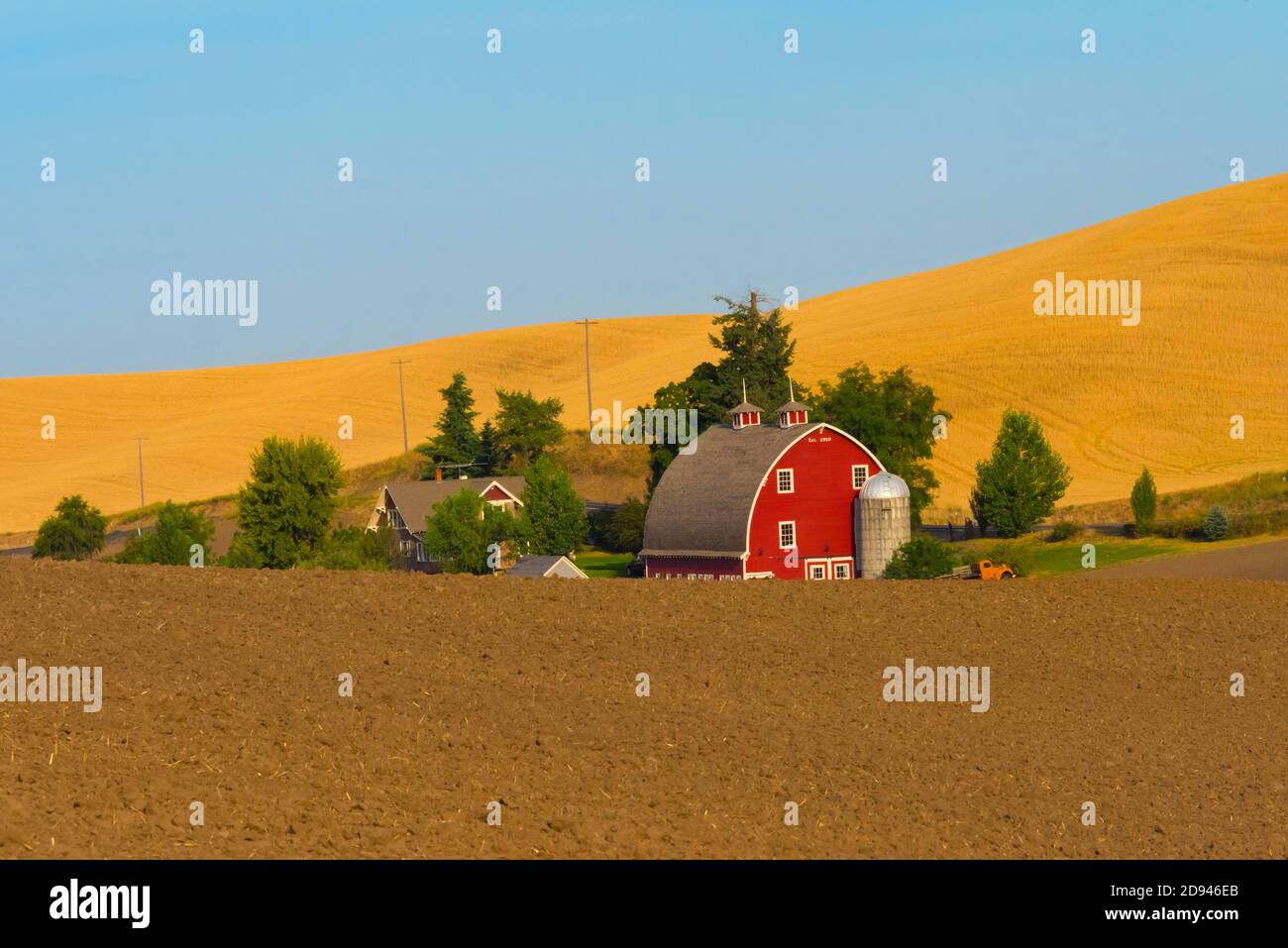 Red barn on wheat field at sunrise, Palouse, Washington State, USA Stock Photo