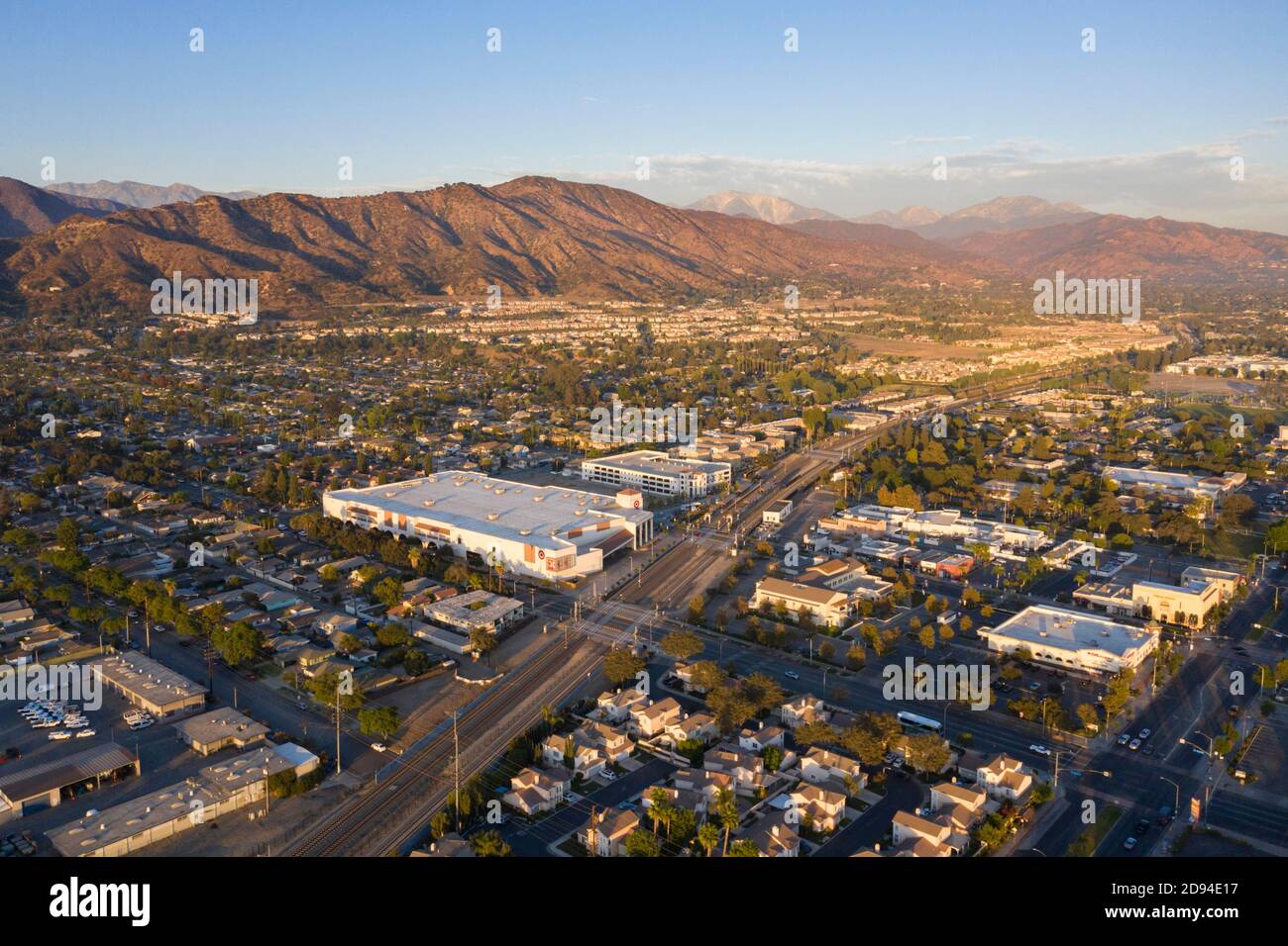 Evening aerial views over downtown Azusa, California and the San Gabriel Mountains at sunset Stock Photo