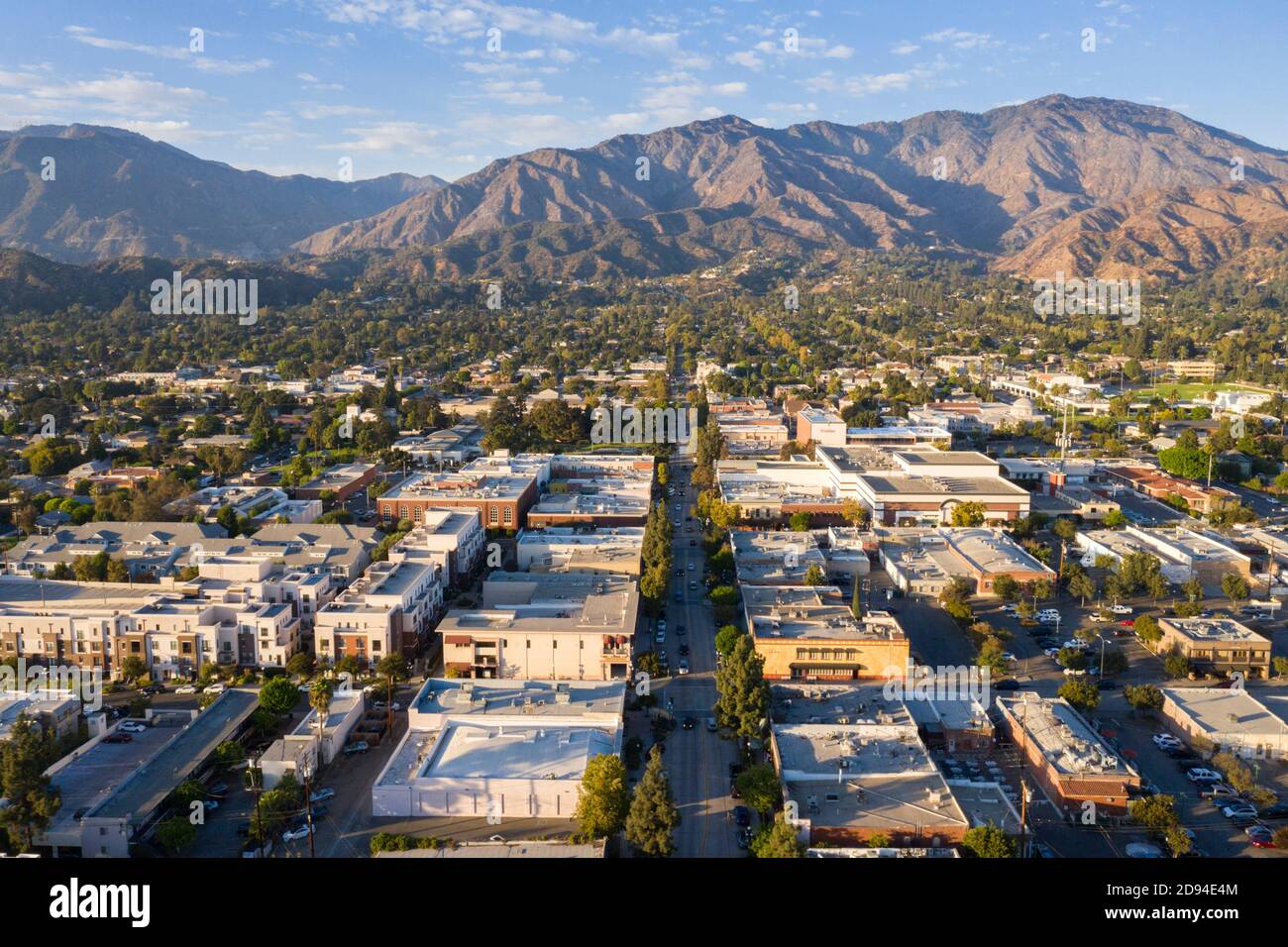 Aerial view above downtown Monrovia California at sunset with San Gabriel Mountains in the distance Stock Photo