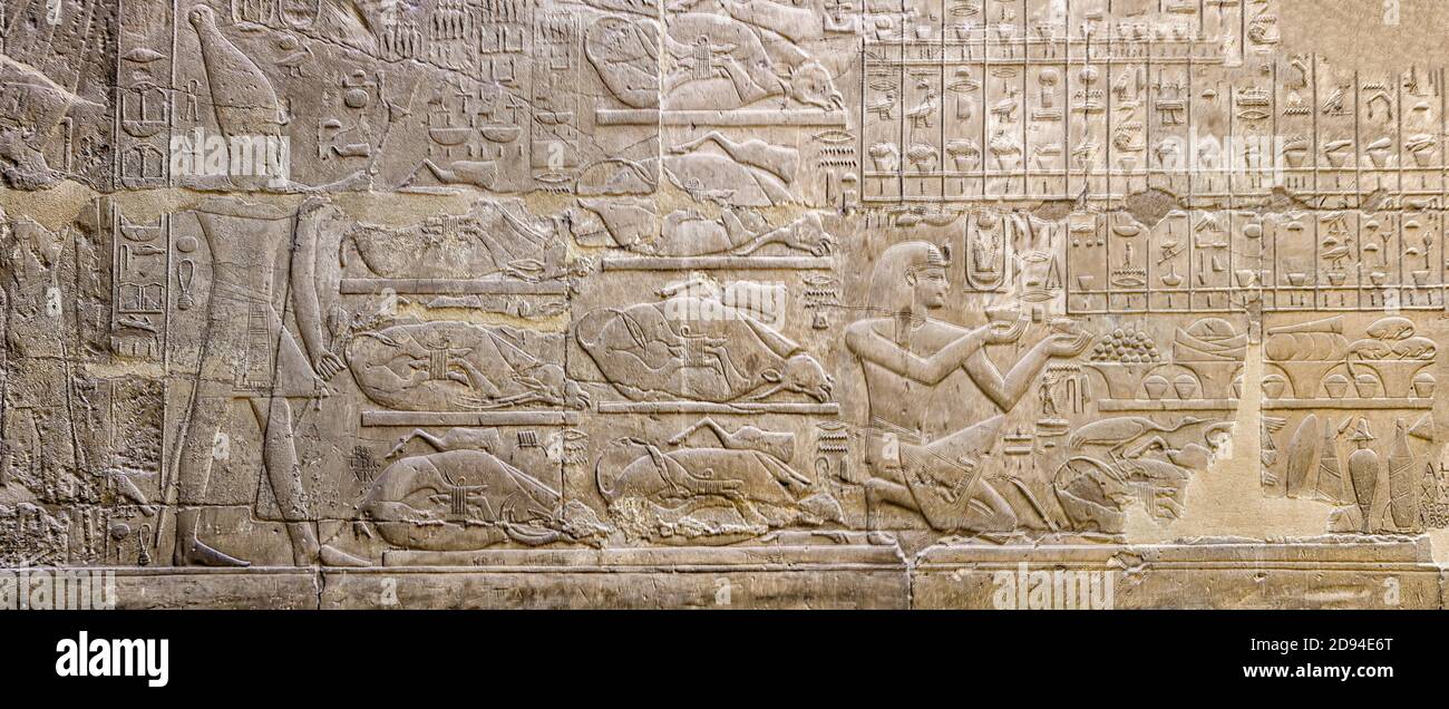 Room XI (Barque Sanctuary) east wall of Luxor Temple depicts Pharaoh Amenhotep III offering incense and libation to Amun Stock Photo