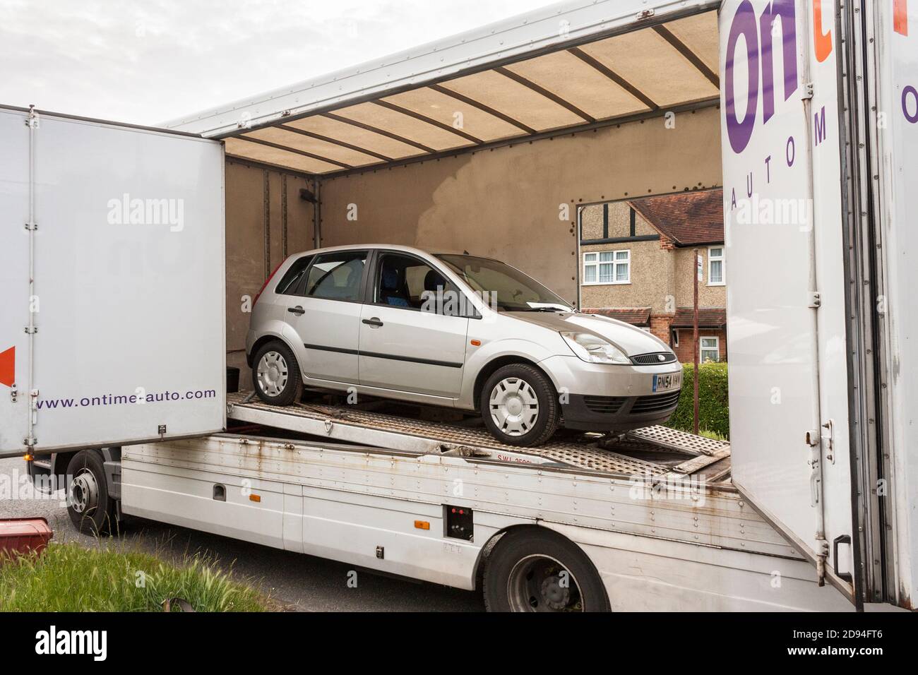 Recovered Ford Fiesta vehicle on HGV on UK street Stock Photo