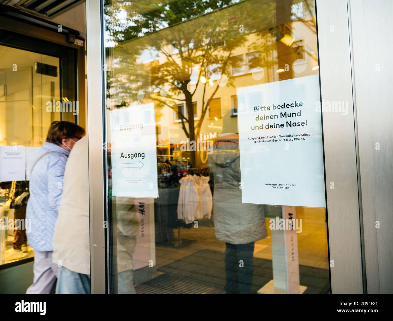 Kehl, Germany - Oct 16, 2020: People entering H and M store with  inscription at the entrance