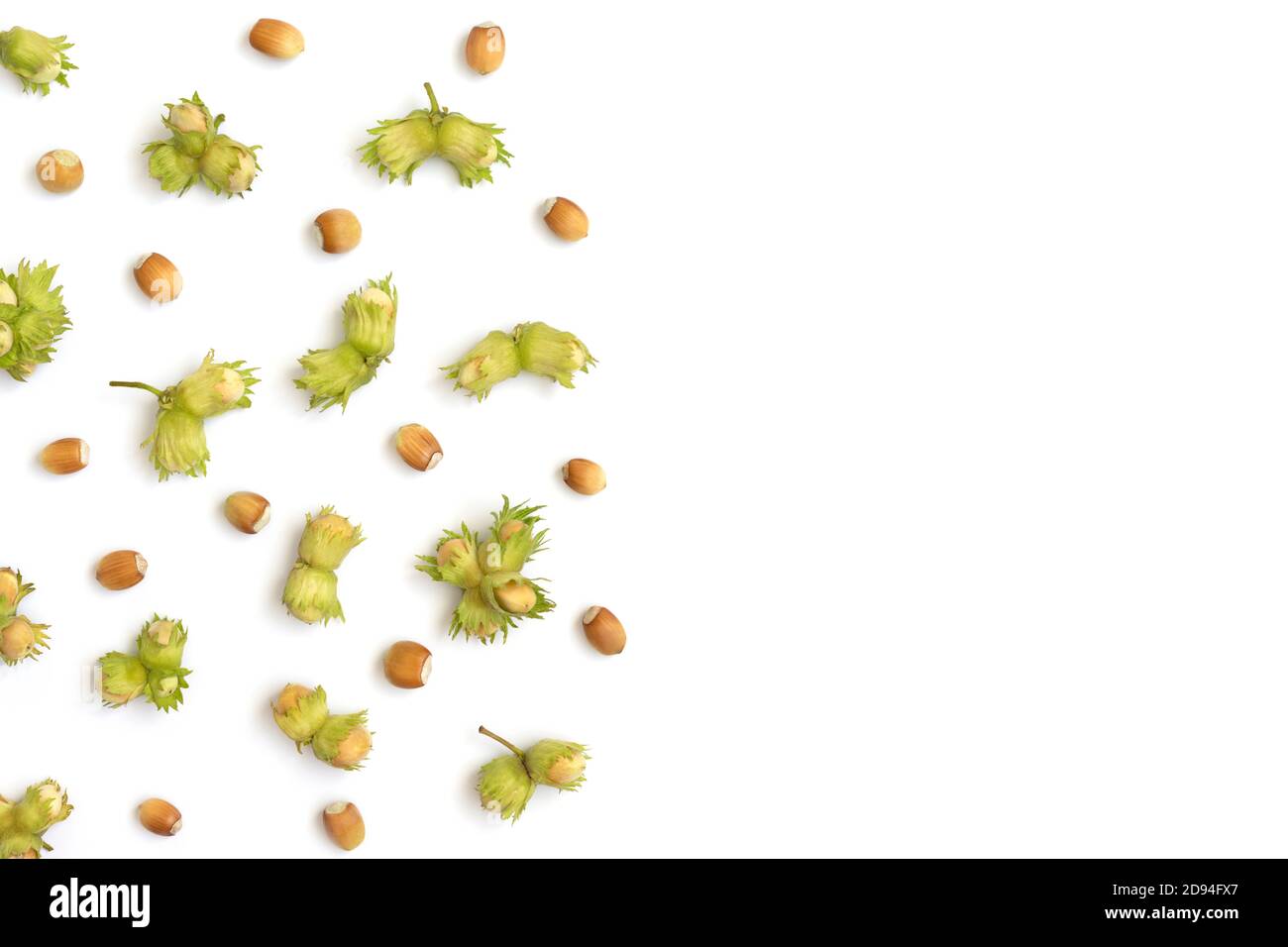 Hazelnuts border. Hazelnuts with green leaves isolated on a white background. Fresh organic nuts. Top view, flat lay, copy space. Stock Photo
