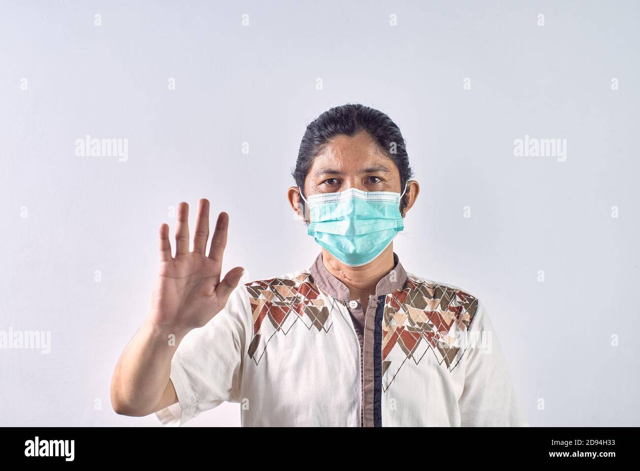 Potrait of asian man showing gesture stop. Asian man wearing surgical mask to protect against contracting viruses and protecting from any pollutions Stock Photo