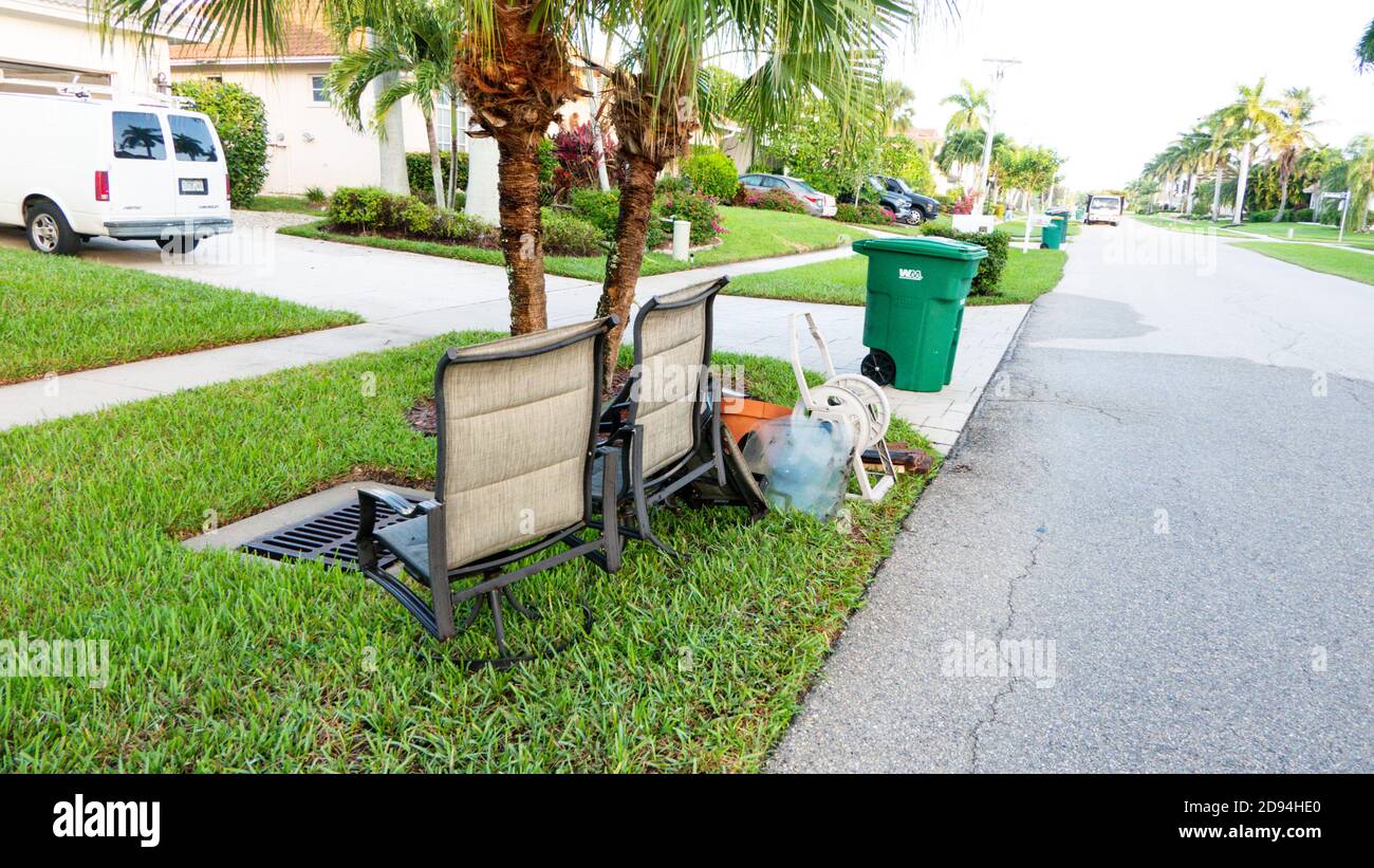 Bulk trash including discarded chairs at curbside for garbage