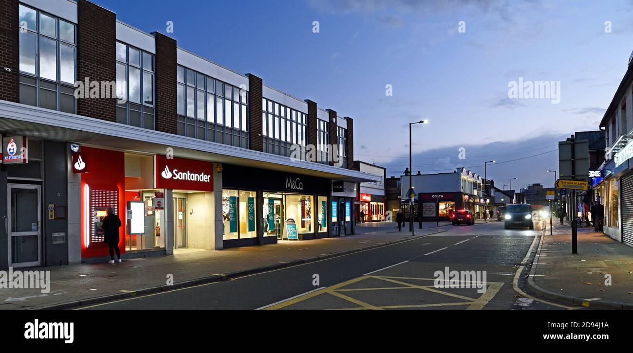 The High Street looking south from the corner of Market Road at Wickford, Essex. UK  Pin point light source above nearest lamp post is planet Jupiter. Stock Photo