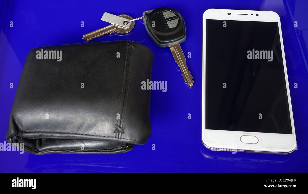 Smartphone and car keys on blue background Stock Photo