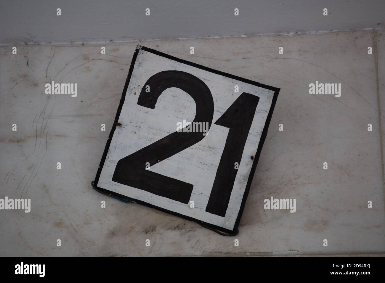 Closeup shot of 21 number on the wall Stock Photo
