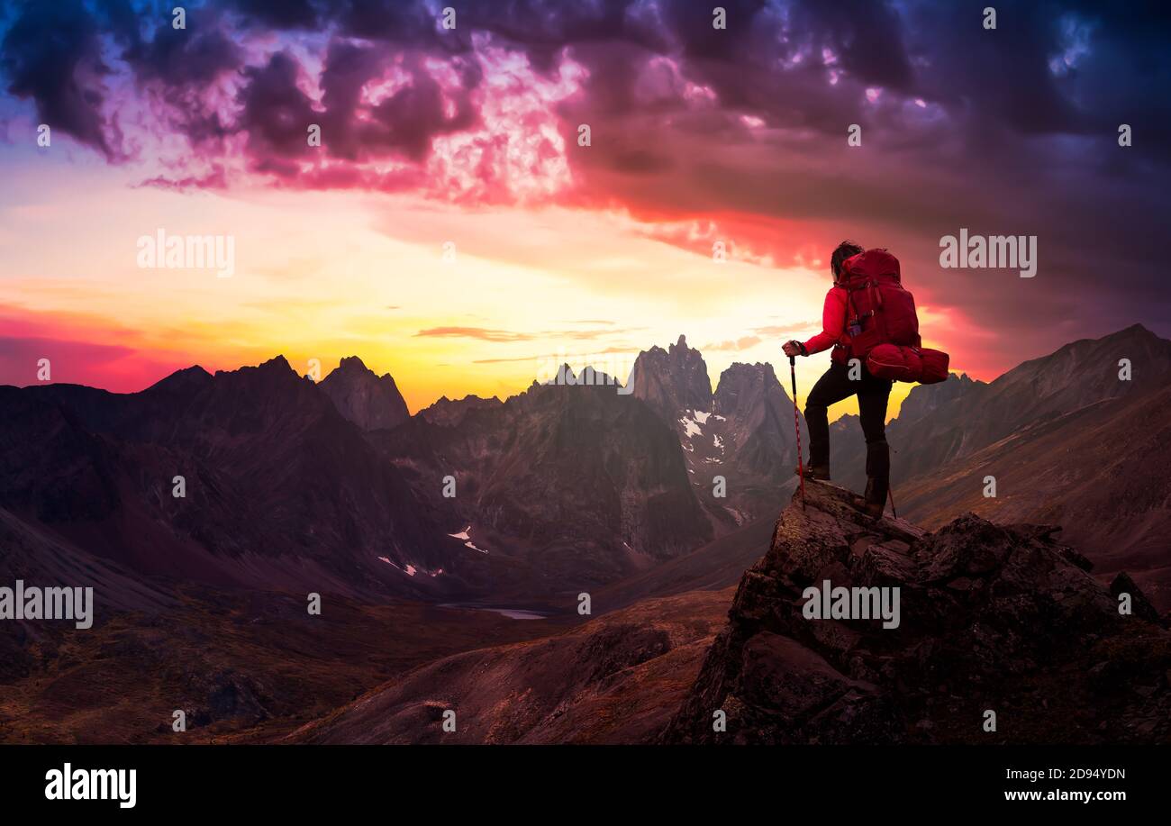 Woman Standing on Rocks looking at Scenic Mountain Peaks and Valley ...