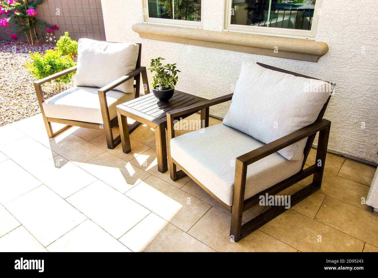 Front Porch With Two Arm Chairs With White Cushions & Small Table Stock ...