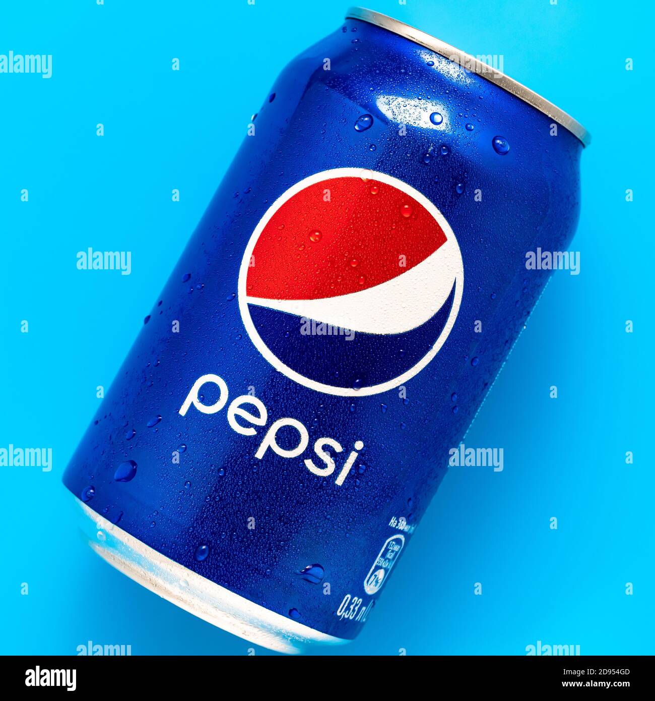 Kharkiv, Ukraine, November 2, 2020: Can of Pepsi cola with water drops on bright blue background. Closed bank of refreshing soft drink. Illustrative e Stock Photo