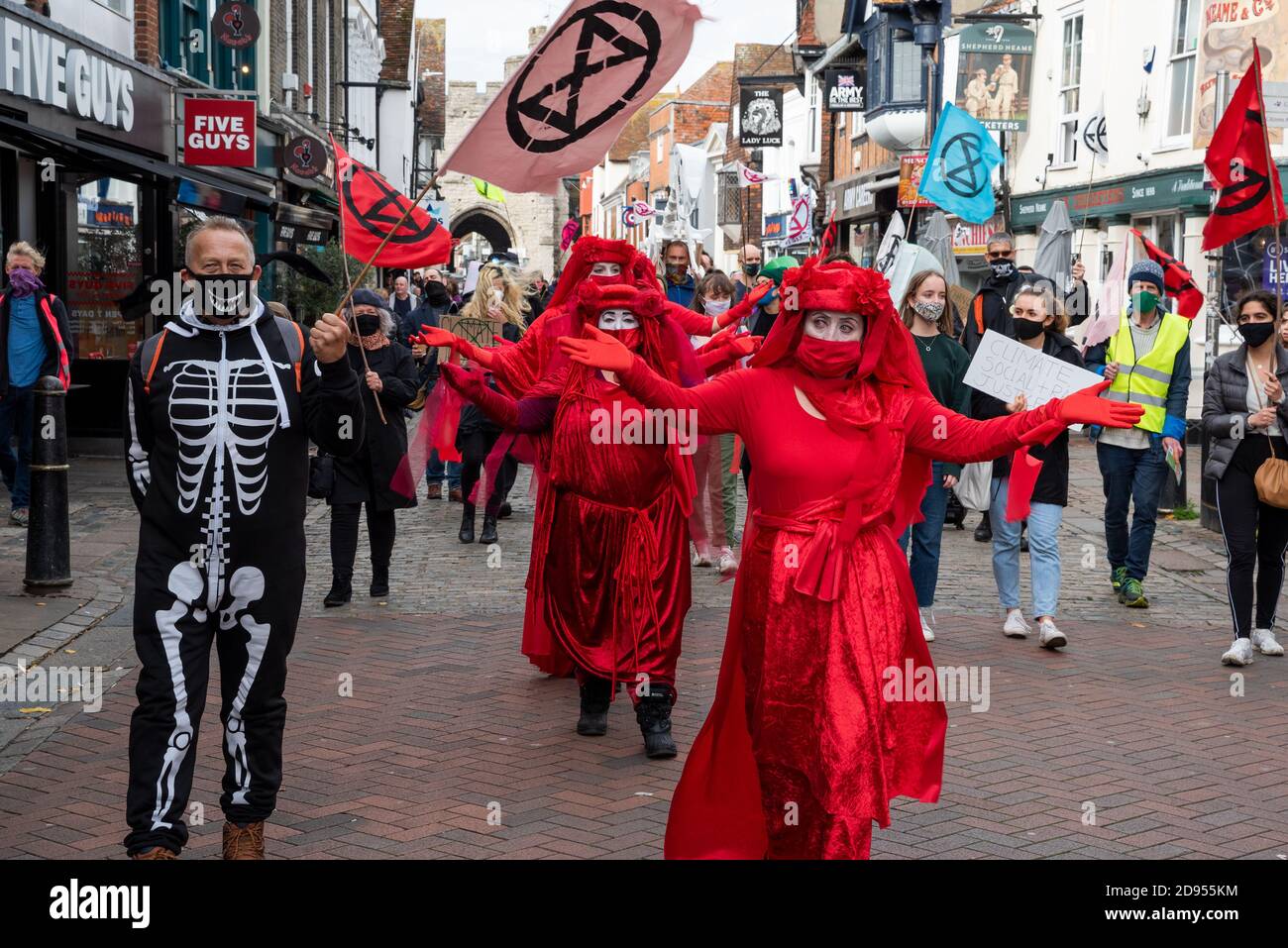Canterbury, UK. 31st October 2020. Extinction Rebellion Procession led by the Red Rebels via Westgate Towers through the centre of Canterbury along the pedestrianised High Street. A new Day of the Dead spectacle in the city involving music, skeletal animals, and the mourning and solace of the Red Rebels. XR say there is a need to call on the government and institutions to Tell The Truth about the climate and ecological crises that we are in and Act Now and get behind the CEE bill. Hosted by Extinction Rebellion Canterbury and Extinction Rebellion Southeast UK. Credit: Stephen Bell/Alamy Stock Photo