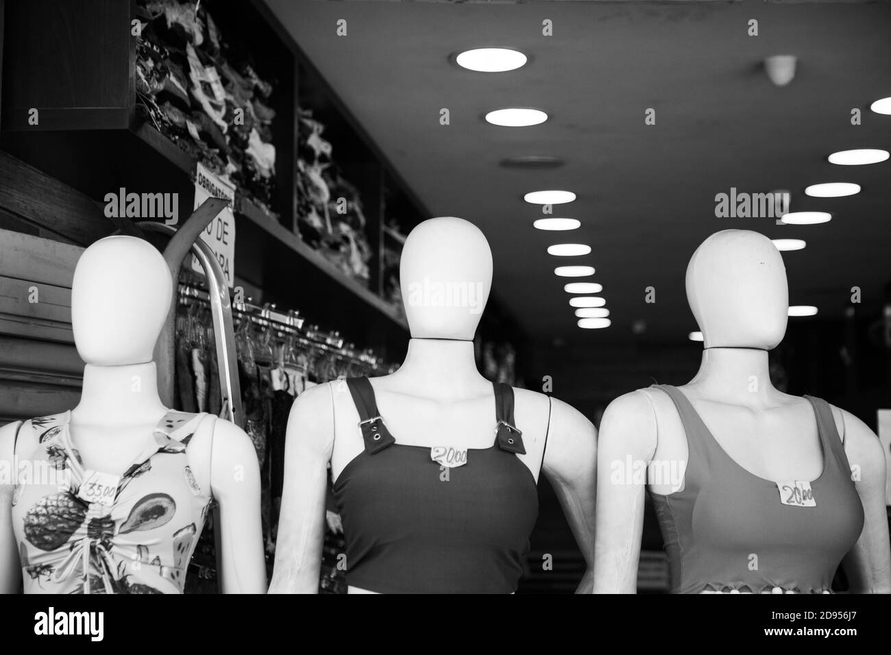 Grayscale shot of mannequins with dresses in a boutique Stock Photo
