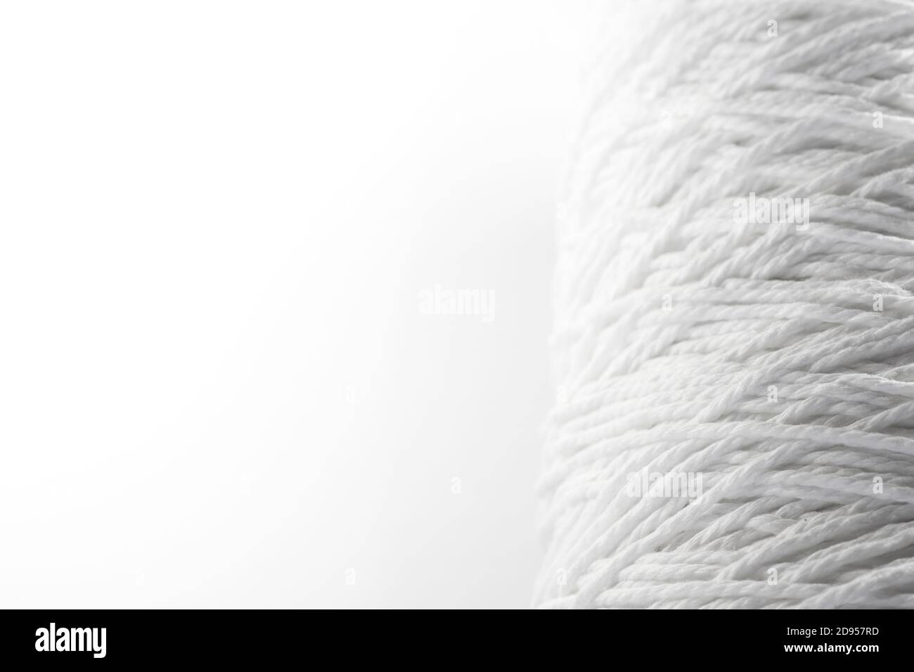 Roll of white rope isolated on white background Stock Photo - Alamy