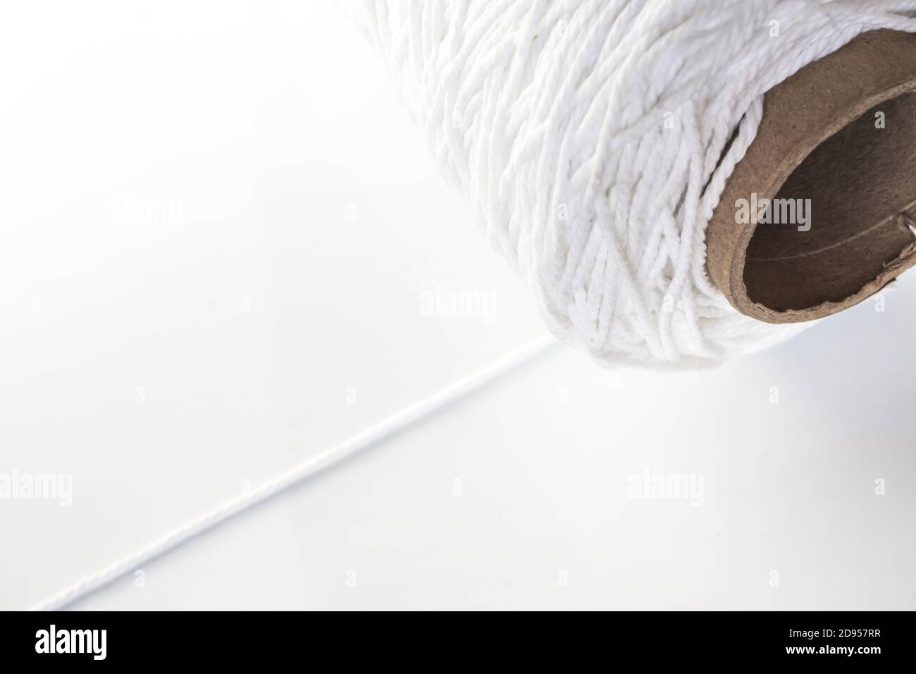 Roll of white rope isolated on white background Stock Photo - Alamy