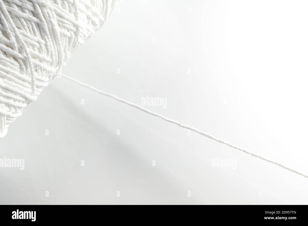 Roll of white rope isolated on white background Stock Photo - Alamy