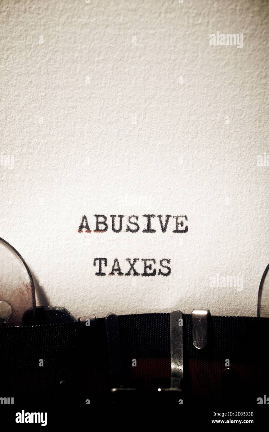 Abusive taxes phrase written with a typewriter. Stock Photo