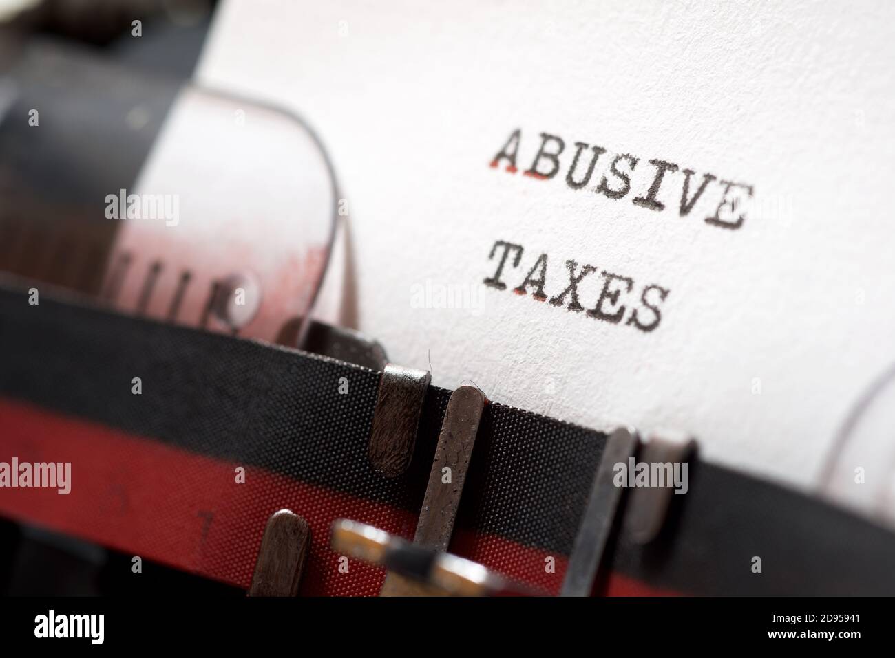 Abusive taxes phrase written with a typewriter. Stock Photo
