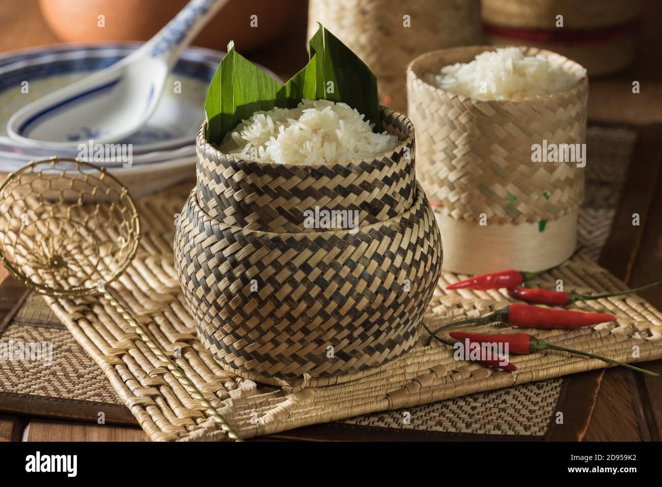 Sticky rice steaming in bamboo baskets over a taoloh at the