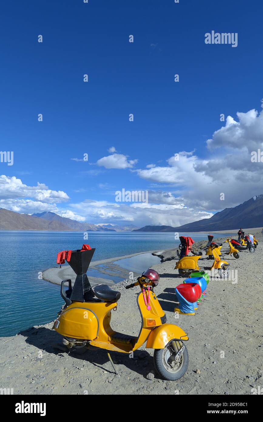 Motorbikes for hire at Pangong Lake in summer. Located in the Changthang region, Ladakh, it is one of the world's highest saltwater lakes Stock Photo