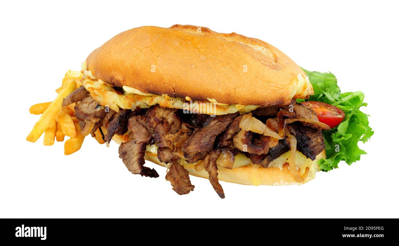 Steak and cheese sandwich with fried onions and French fries in a crusty bread roll isolated on a white background Stock Photo