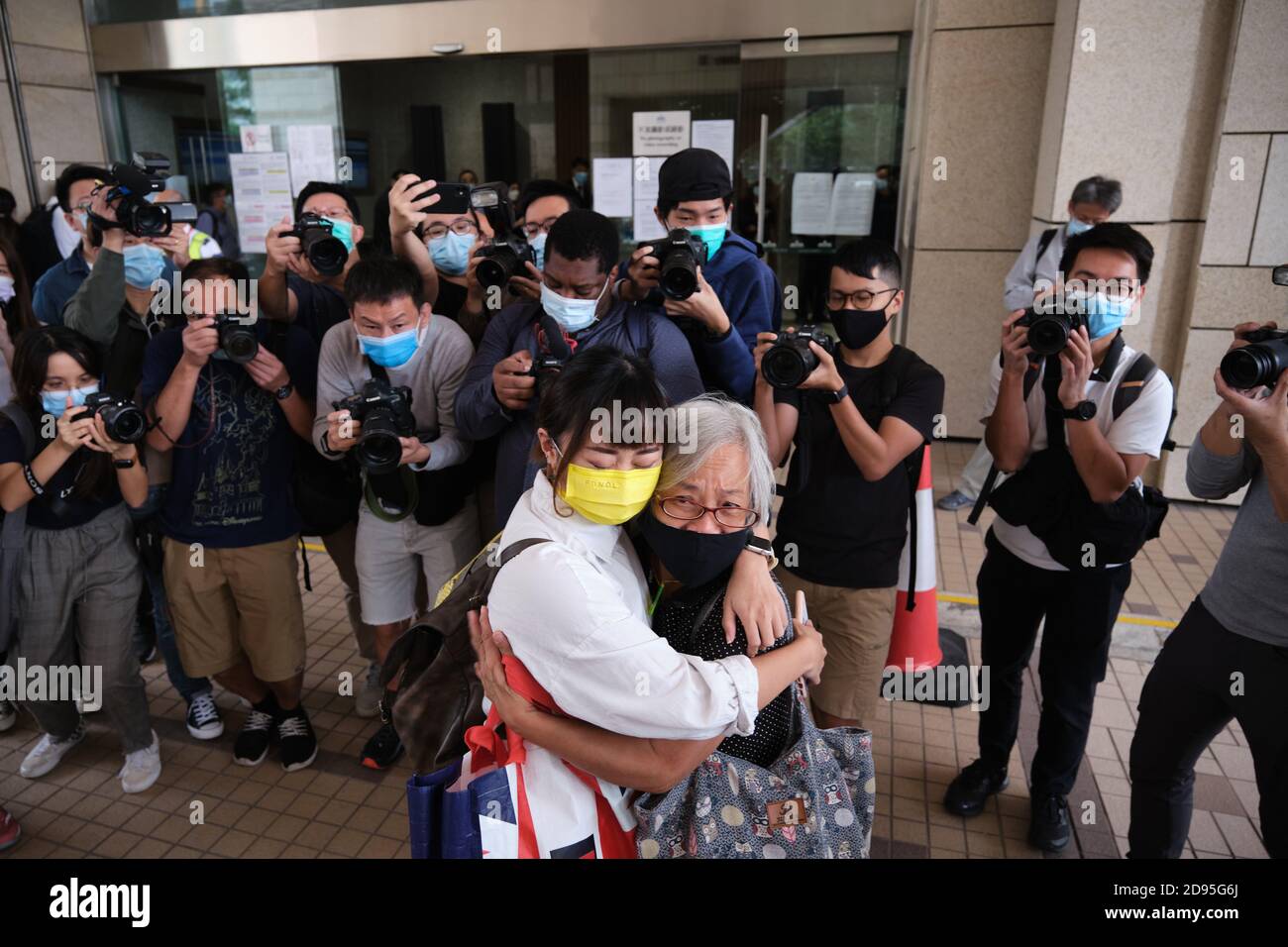 Hong Kong, China. 03rd Nov, 2020. Activists Tiffany Yuen (L) and Alexandra Wong (R), also known as 'Grandma Wong', hug each other as Yuen arrives at West Kowloon Magistrates' Court.26 Hong Kong pro-democracy activists including media tycoon Jimmy Lai and Joshua Wong appear in court after being charged with participating in or inciting others to take part in an illegal assembly related to a banned June 4 vigil commemorating the Tiananmen Sqaure crackdown. Credit: SOPA Images Limited/Alamy Live News Stock Photo