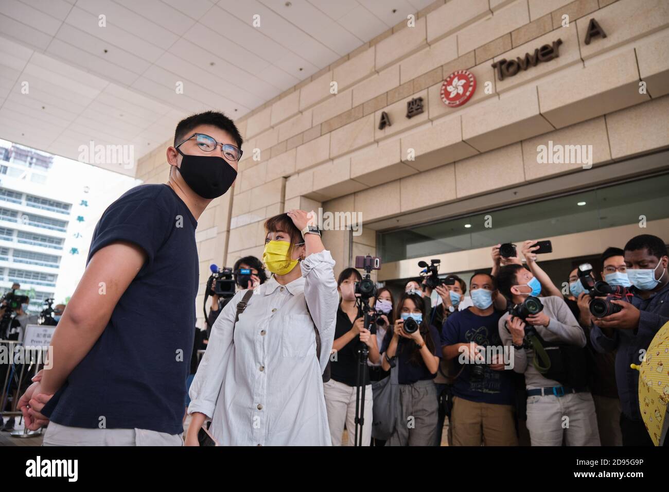 Hong Kong, China. 03rd Nov, 2020. Pro-democracy activists Joshua Wong (L) and Tiffany Yuen (R) wearing face masks arrive at West Kowloon Magistrates' Court with other activists.26 Hong Kong pro-democracy activists including media tycoon Jimmy Lai and Joshua Wong appear in court after being charged with participating in or inciting others to take part in an illegal assembly related to a banned June 4 vigil commemorating the Tiananmen Sqaure crackdown. Credit: SOPA Images Limited/Alamy Live News Stock Photo