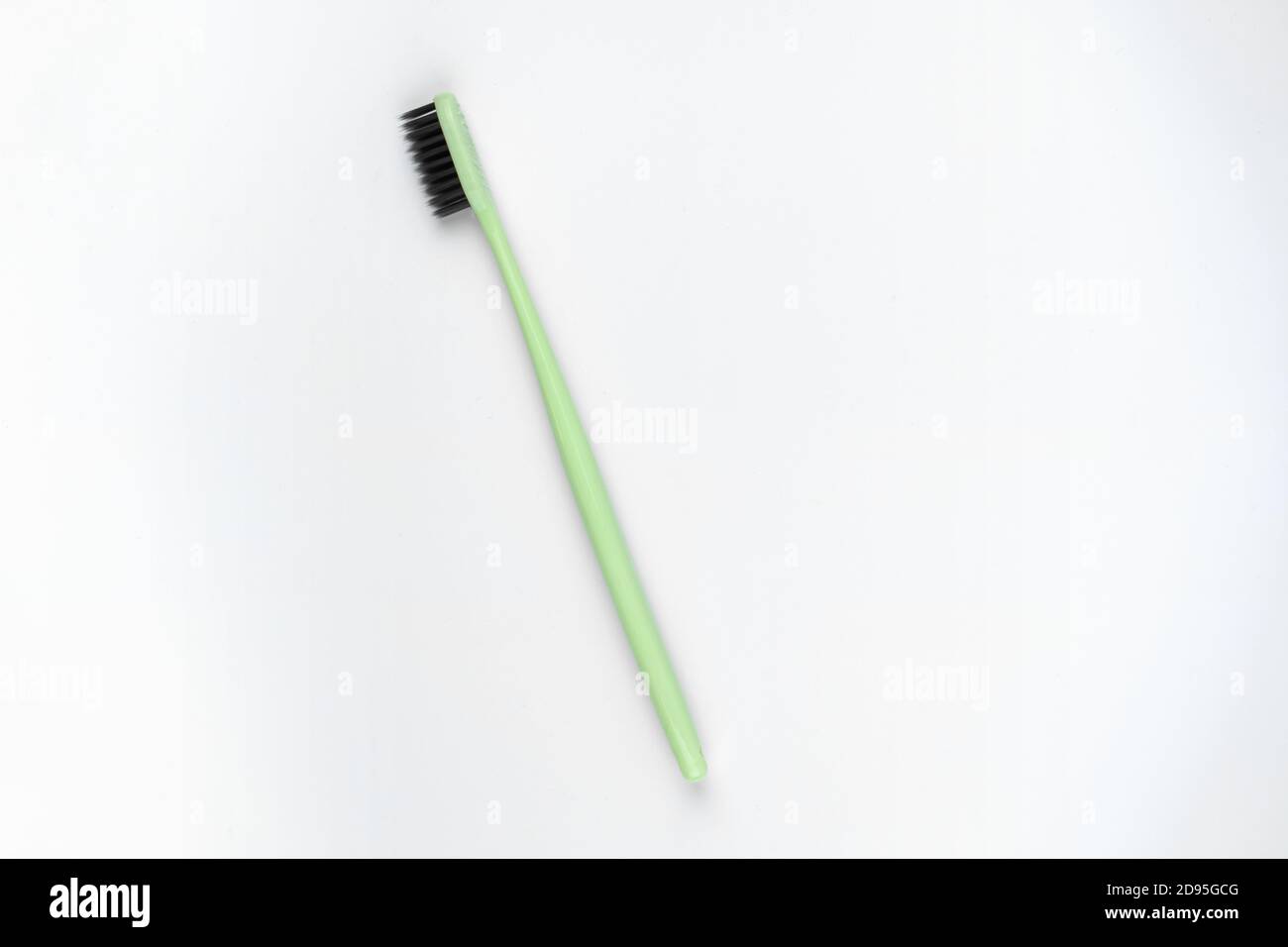 Photo of green toothbrush on isolated white background Stock Photo - Alamy