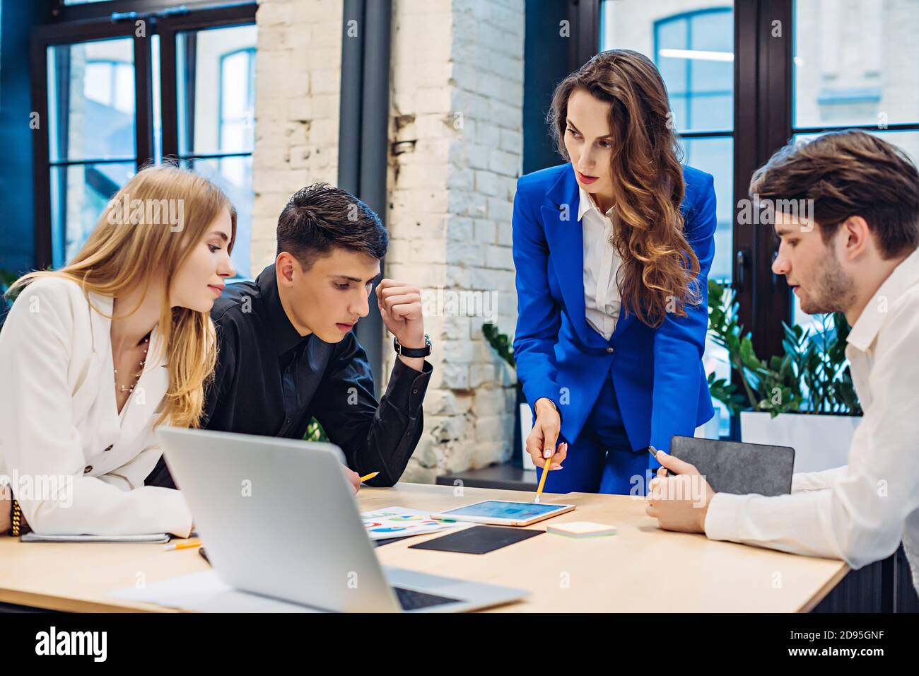 Businesswoman show graph on tablet to colleagues Stock Photo
