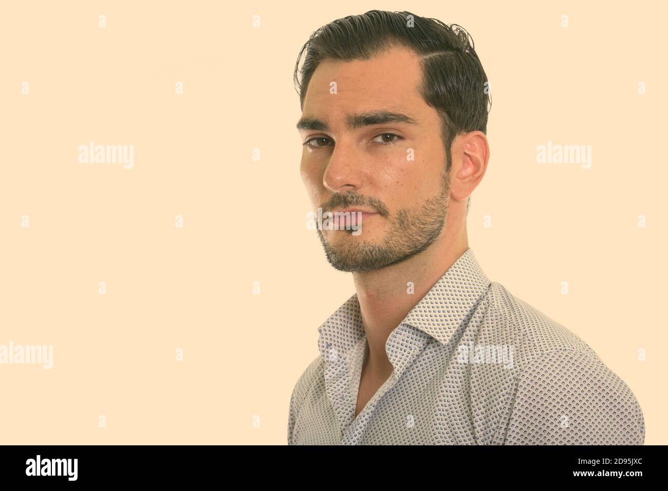 Portrait of young handsome bearded businessman looking at camera Stock ...