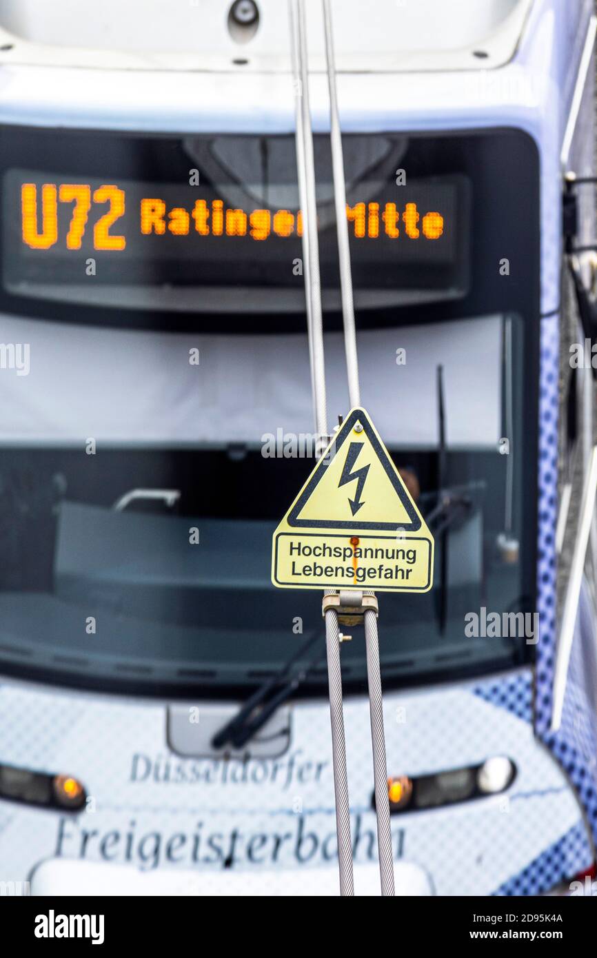 U-Bahn and the overhead line with the warning sign high voltage, danger to life Stock Photo