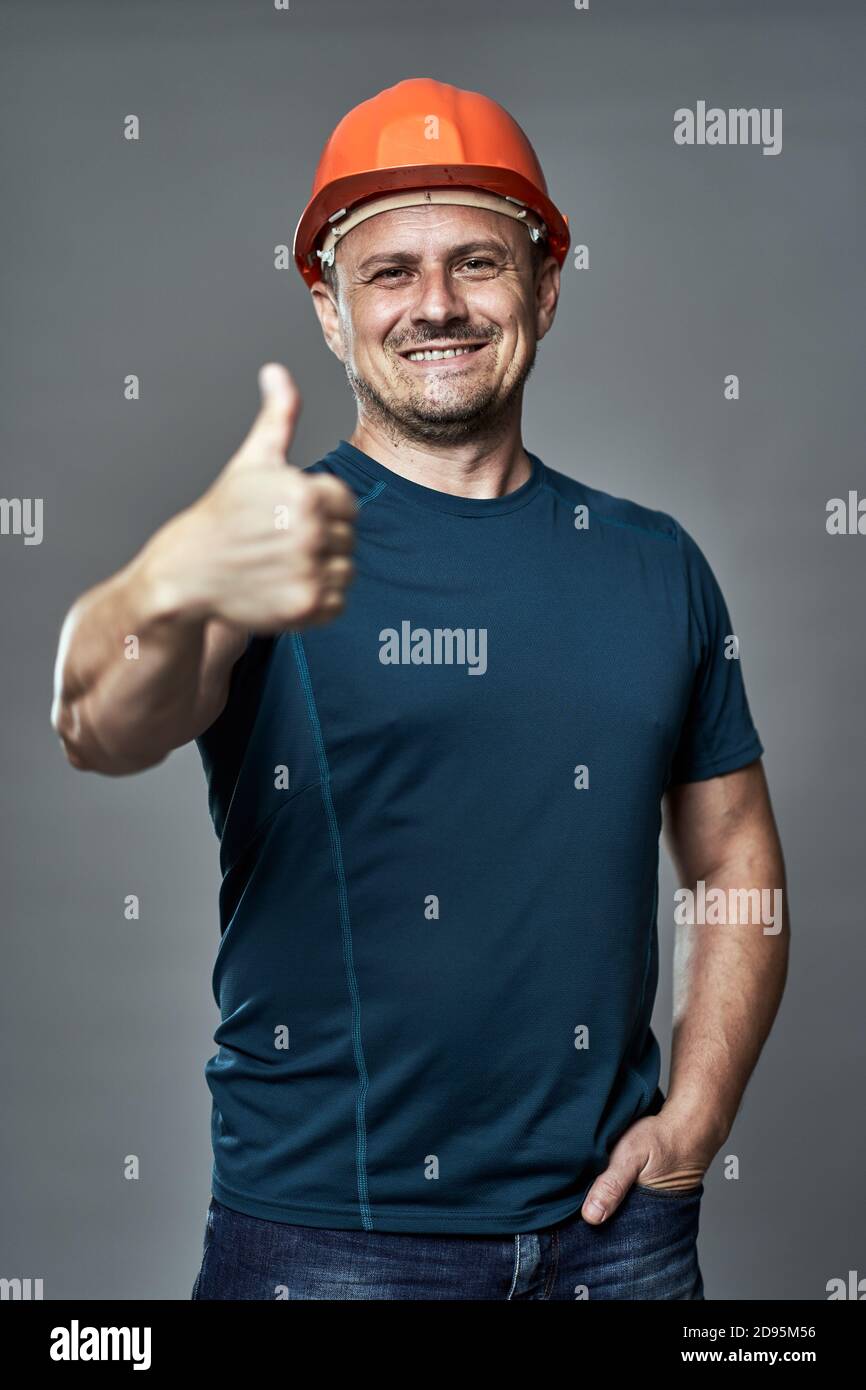 Engineer in hard hat making thumbs up sign Stock Photo Alamy