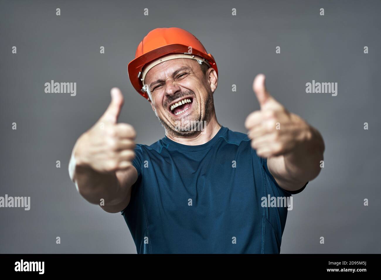 Engineer in hard hat making thumbs up sign Stock Photo Alamy