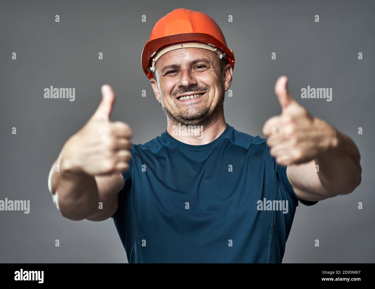 Engineer in hard hat making thumbs up sign Stock Photo Alamy