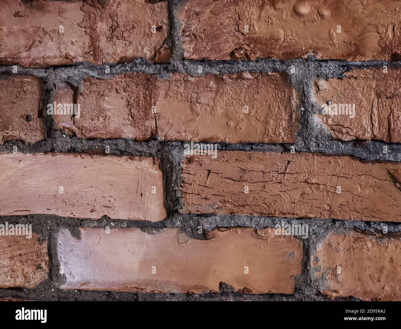 close-up photo of a section of a red brown brick wall with selective focuse. Stock Photo