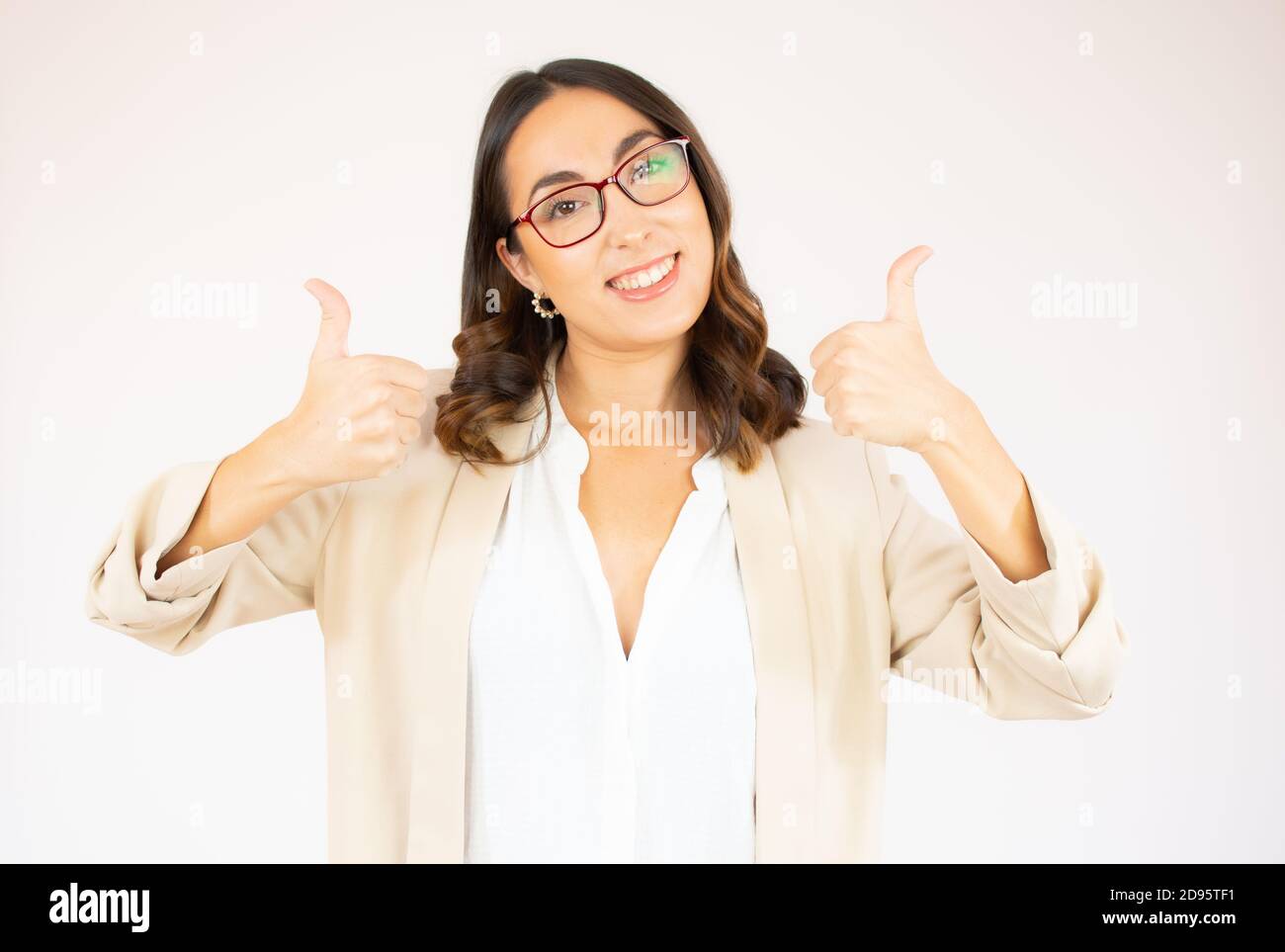 Smiling pretty young business woman showing thumbs up isolated on the ...
