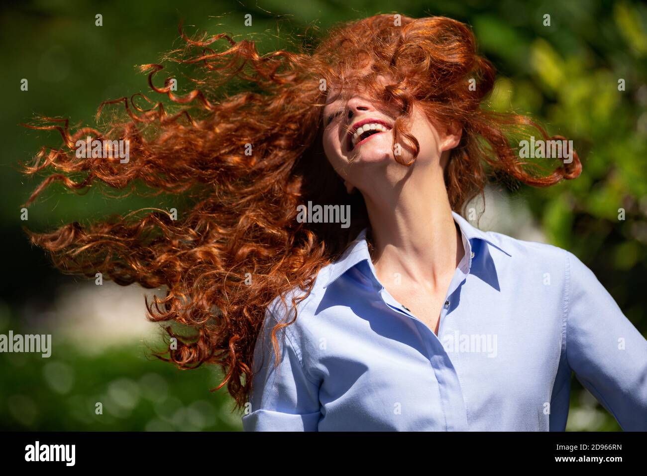 Cute young woman with streaming hair is laughing at the camera Stock ...