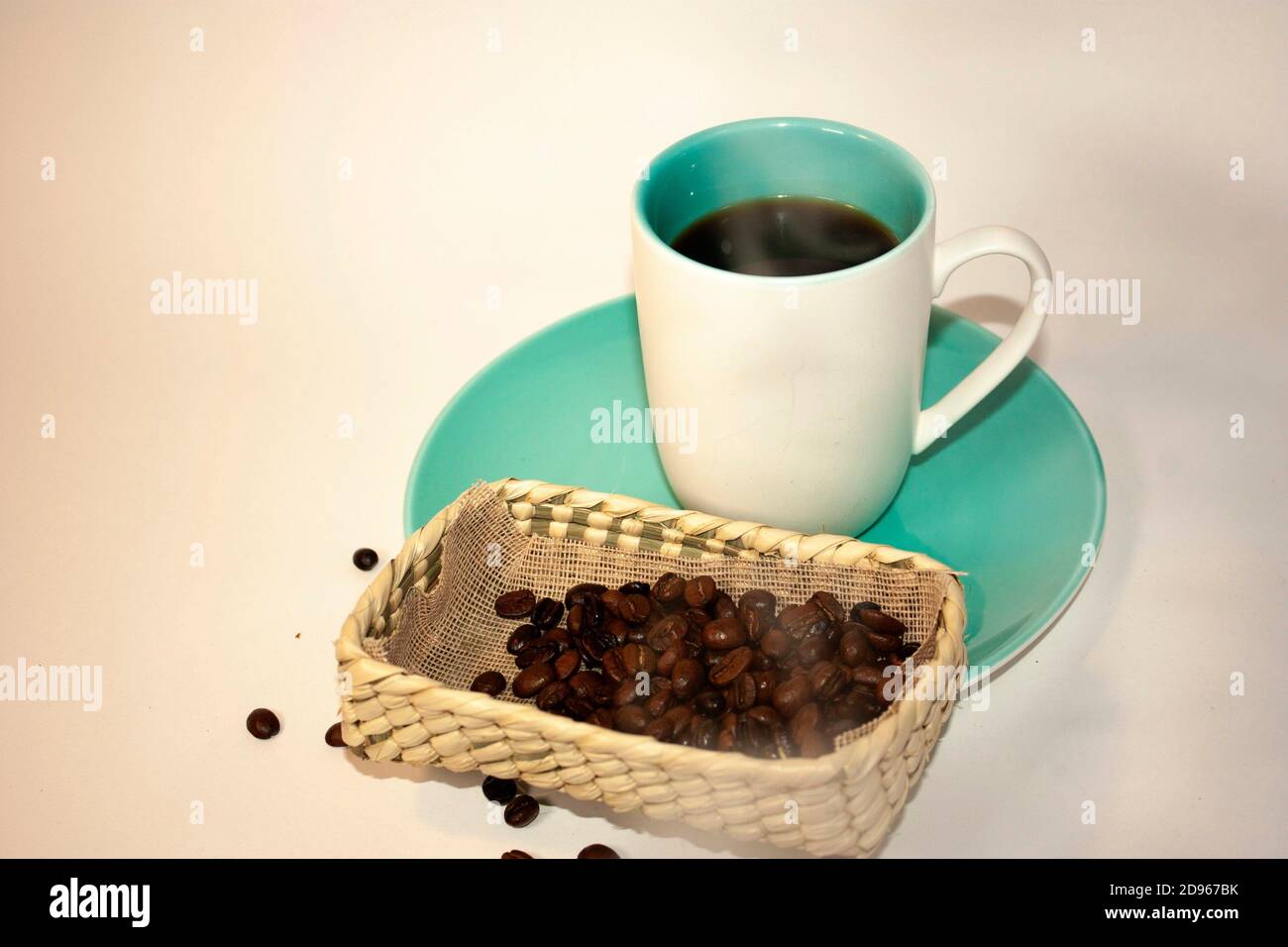 Cup Glass Of Coffee With Smoke And Coffee Beans On Old Wooden