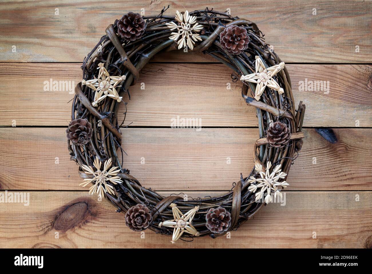 Rustic Christmas wreath on wooden planks background with copy space Stock Photo