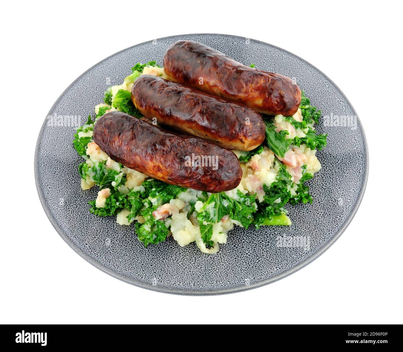 Traditional Irish Colcannon and sausage meal, Colcannon is made with mashed potato and kale or cabbage, isolated on a white background Stock Photo