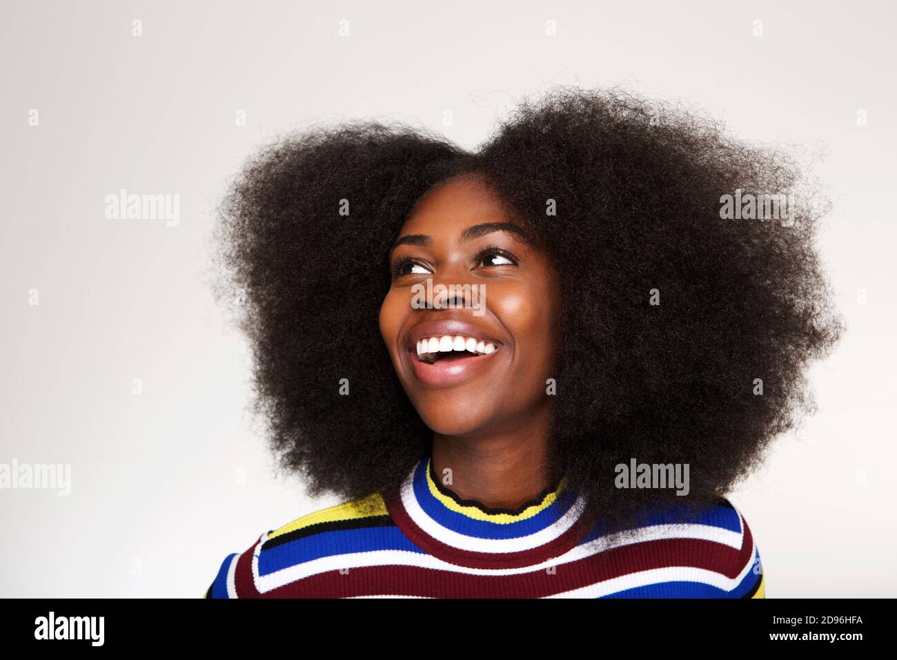 Close up horizontal portrait of young black woman laughing and looking ...