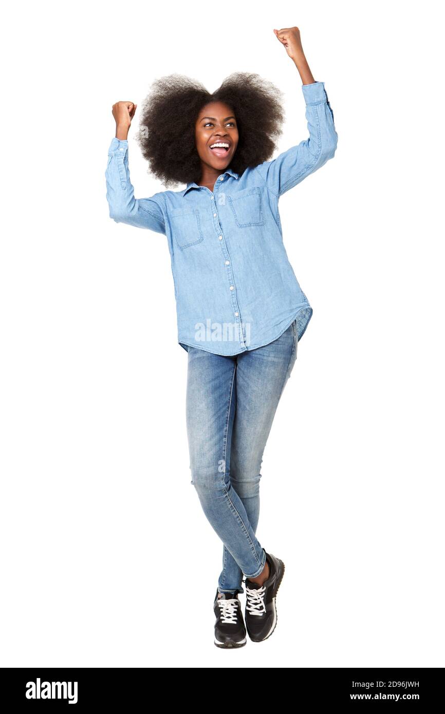Full length portrait of happy young woman cheering with hands raised ...