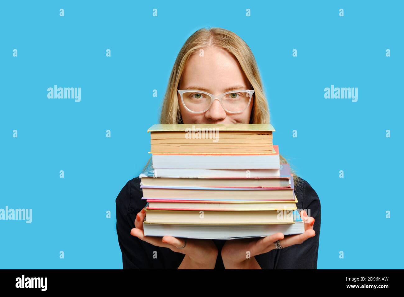 Close up portrait of joyful Caucasian student girls with books in hands. Stock Photo