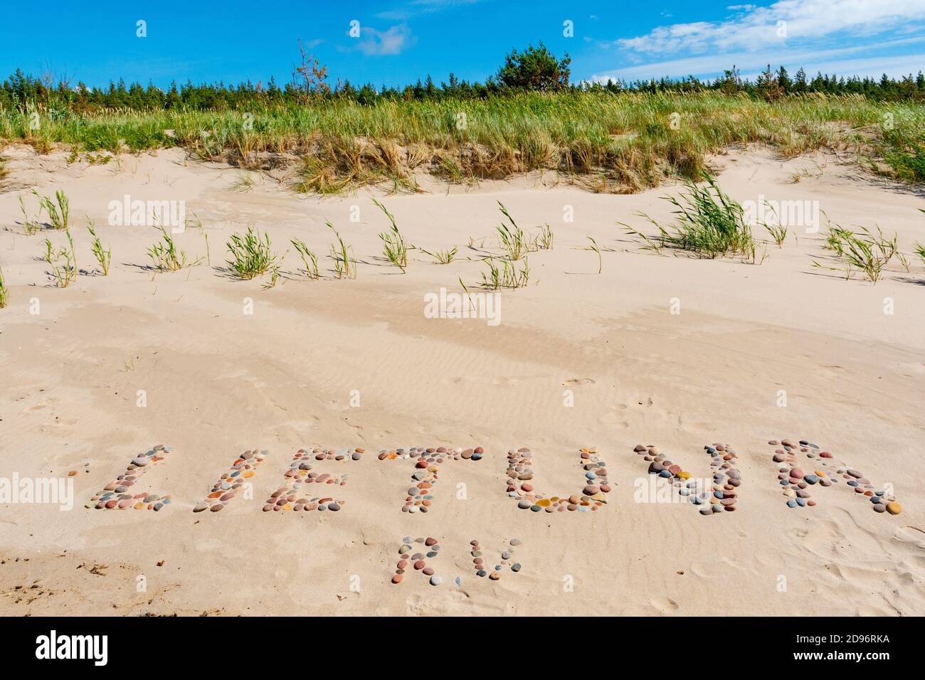 Lietuva word written with stones on the shore, sandy beach on the Baltic Sea in Lithuania Stock Photo